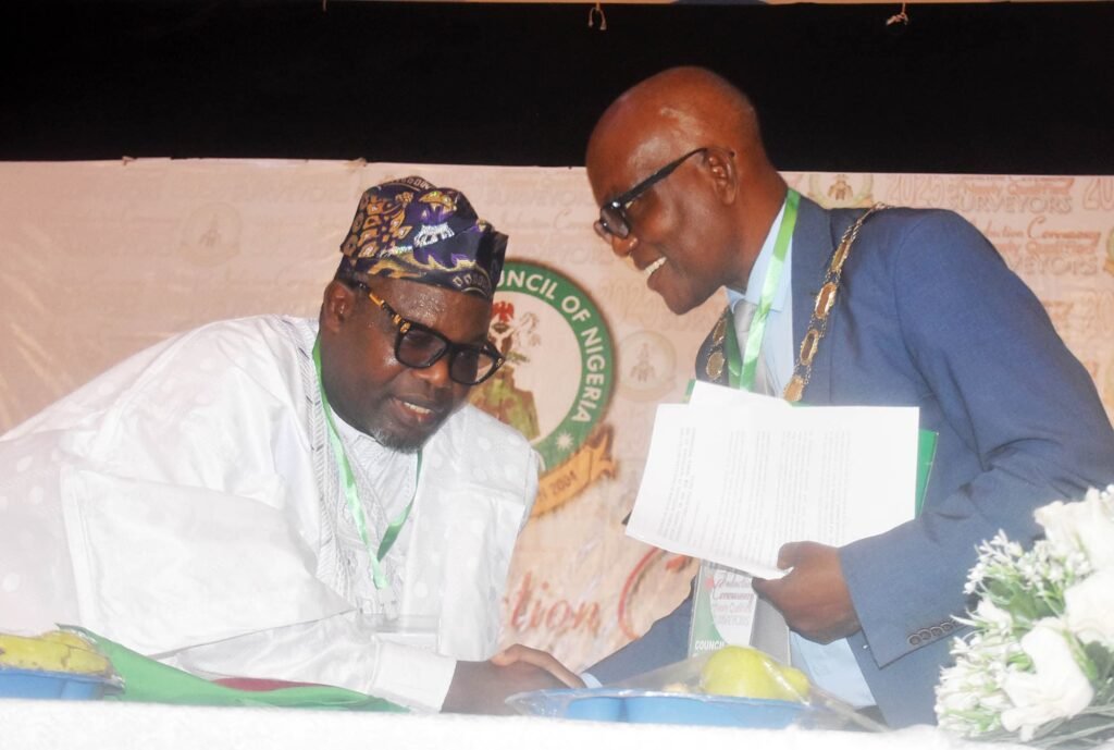 President, Nigerian Institution of Surveyors, Ibitoye Matthew-Olomolatan (R), with the Surveyor-General of the Federation, Abdulganiyu Adebomehin, during the induction of Surveyors in Abuja on Thursday (24/4/25).